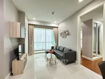 Modern living room with sleek furniture and large windows in a stylish apartment.