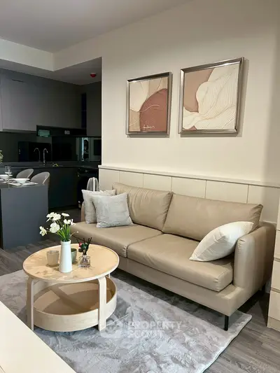 Modern living room with beige sofa and stylish decor in open-plan layout