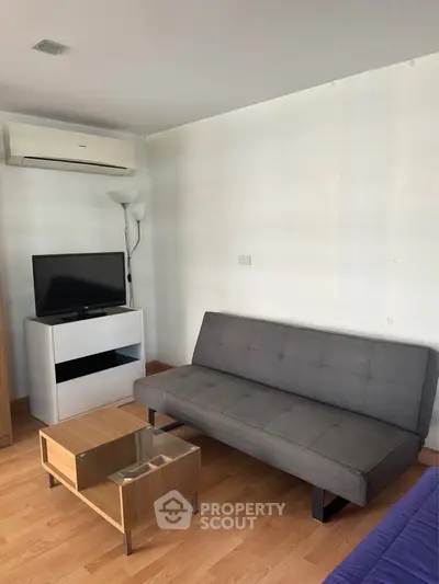 Modern living room with sleek furniture and air conditioning, perfect for comfortable living.