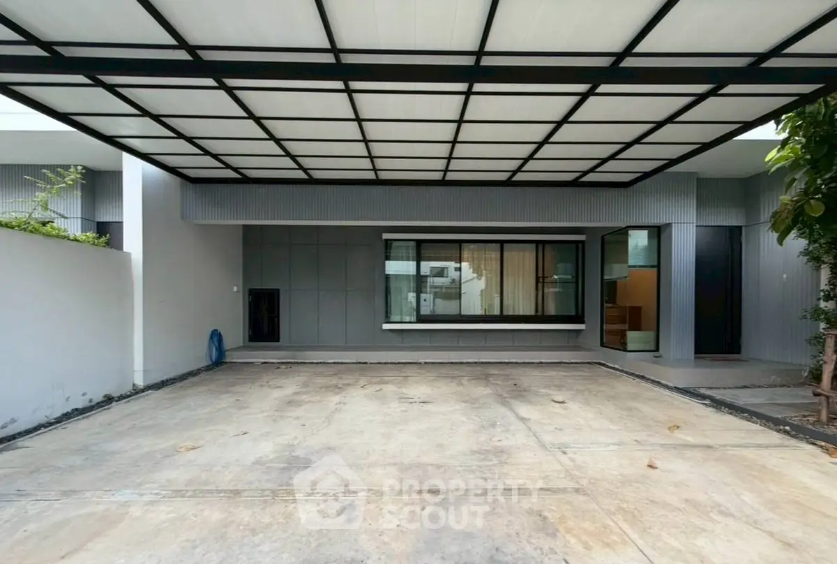Modern covered parking area with sleek design and large window