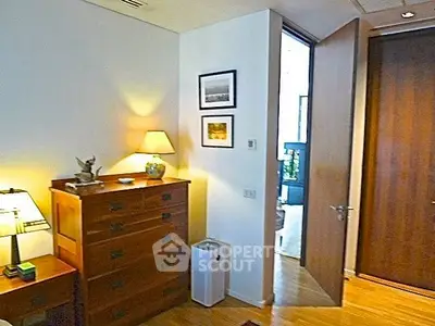 Cozy bedroom with wooden furniture and soft lighting, perfect for relaxation.