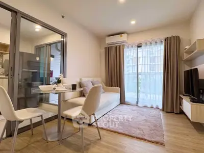 Modern living room with cozy seating and natural light in a stylish apartment.