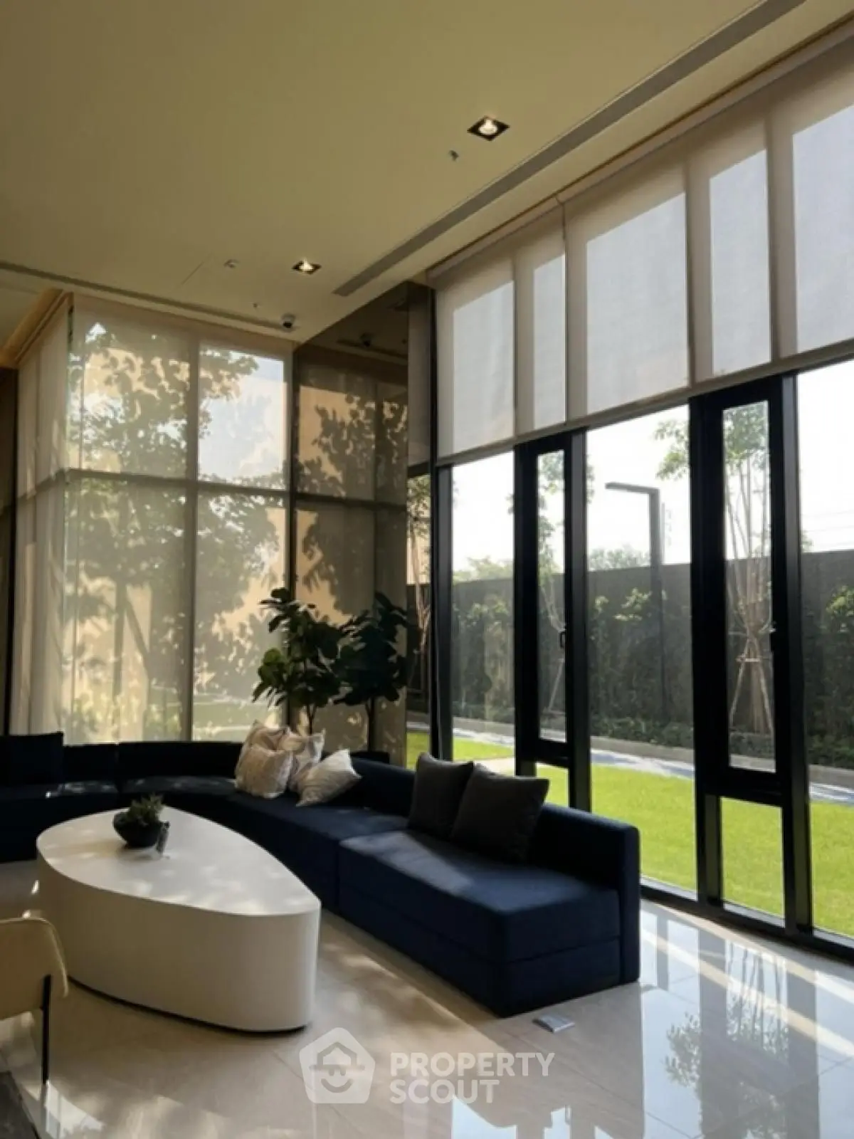 Luxurious living room with floor-to-ceiling windows and garden view