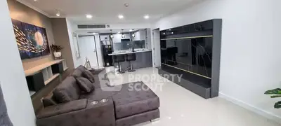 Modern living room with sleek furniture and open kitchen layout