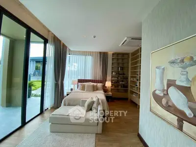 Luxurious bedroom with floor-to-ceiling windows and elegant decor, offering a serene garden view.