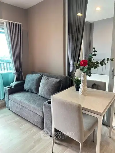 Cozy living room with modern sofa and dining table, perfect for urban living.