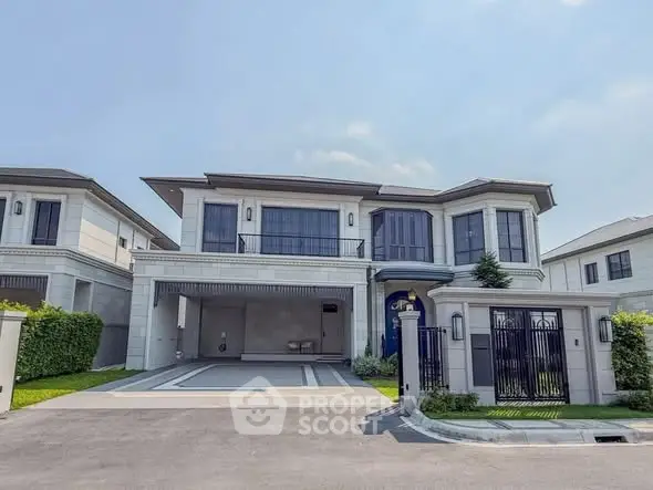 Luxurious modern two-story house with spacious driveway and elegant facade in a serene neighborhood.