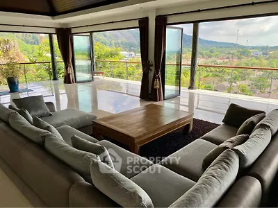Spacious living room with panoramic views and large balcony access.