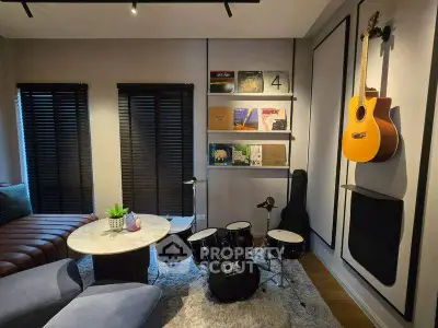 Stylish music-themed living room with drum set and guitar, perfect for musicians.
