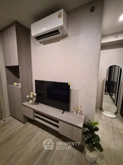 Modern living room with sleek furniture and air conditioning unit, perfect for comfortable living.