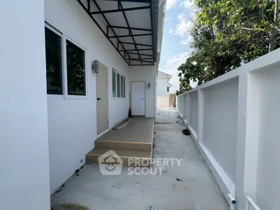 Modern exterior with sleek design and spacious walkway, perfect for contemporary living.