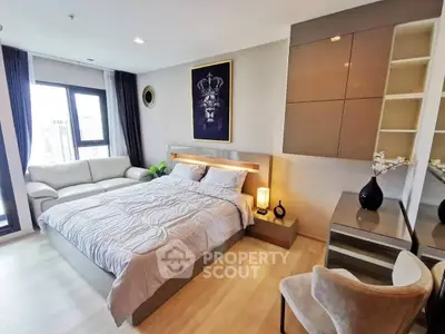 Luxurious modern bedroom with elegant decor and large windows offering natural light.