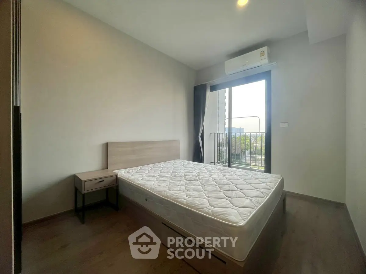 Modern bedroom with balcony access and natural light