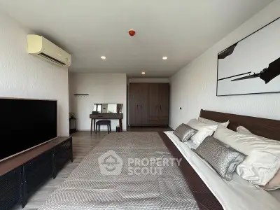 Spacious modern bedroom with stylish decor and large bed in a luxury apartment.