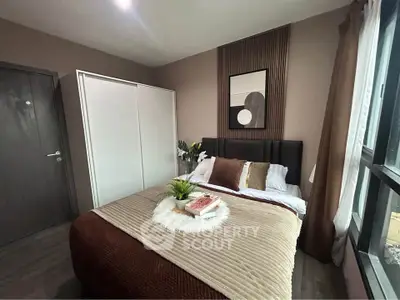 Cozy bedroom with modern decor, large window, and stylish bedding in a contemporary apartment.