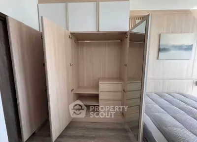 Spacious bedroom with open wardrobe and modern decor