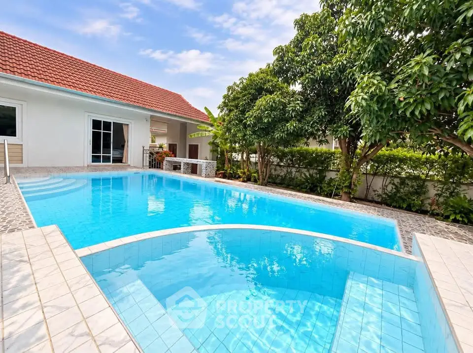 Luxurious private pool with lush garden in modern villa setting