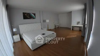 Spacious modern bedroom with elegant decor and natural light