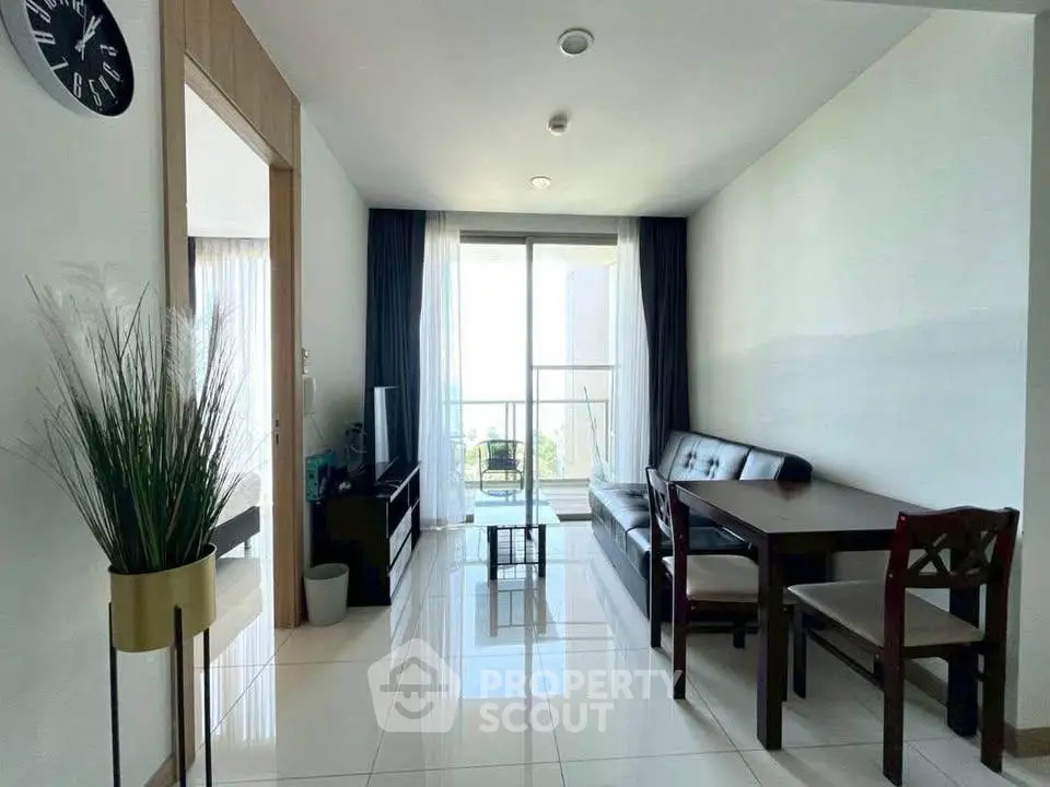 Modern living room with sleek furniture and balcony view in a stylish apartment.