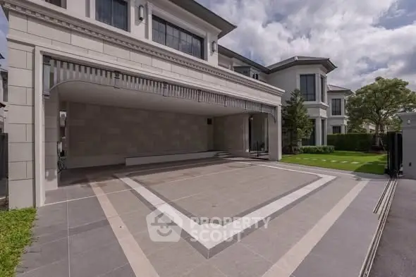 Luxurious modern home exterior with spacious driveway and elegant architectural design.