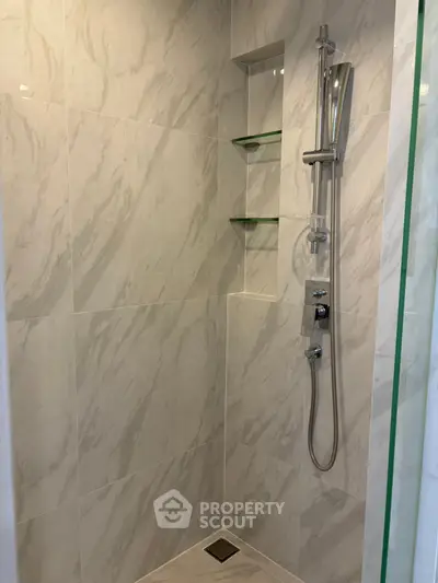 Elegant modern shower with marble tiles and sleek fixtures