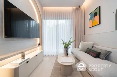 Modern living room with sleek design, featuring a large wall-mounted TV, stylish sofa, and elegant decor.