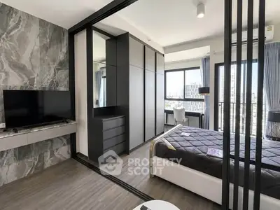 Modern bedroom with sleek design and city view, featuring a stylish TV setup and ample storage space.
