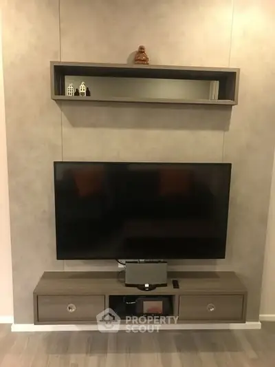 Modern living room with sleek TV setup and stylish shelving