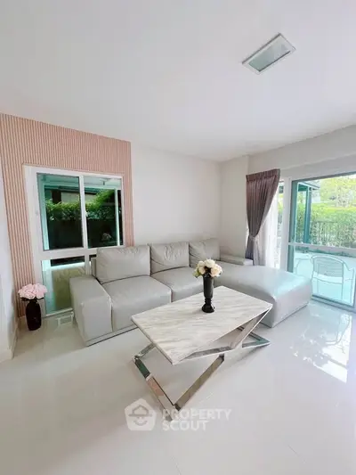 Modern living room with sleek white sofa and elegant marble coffee table