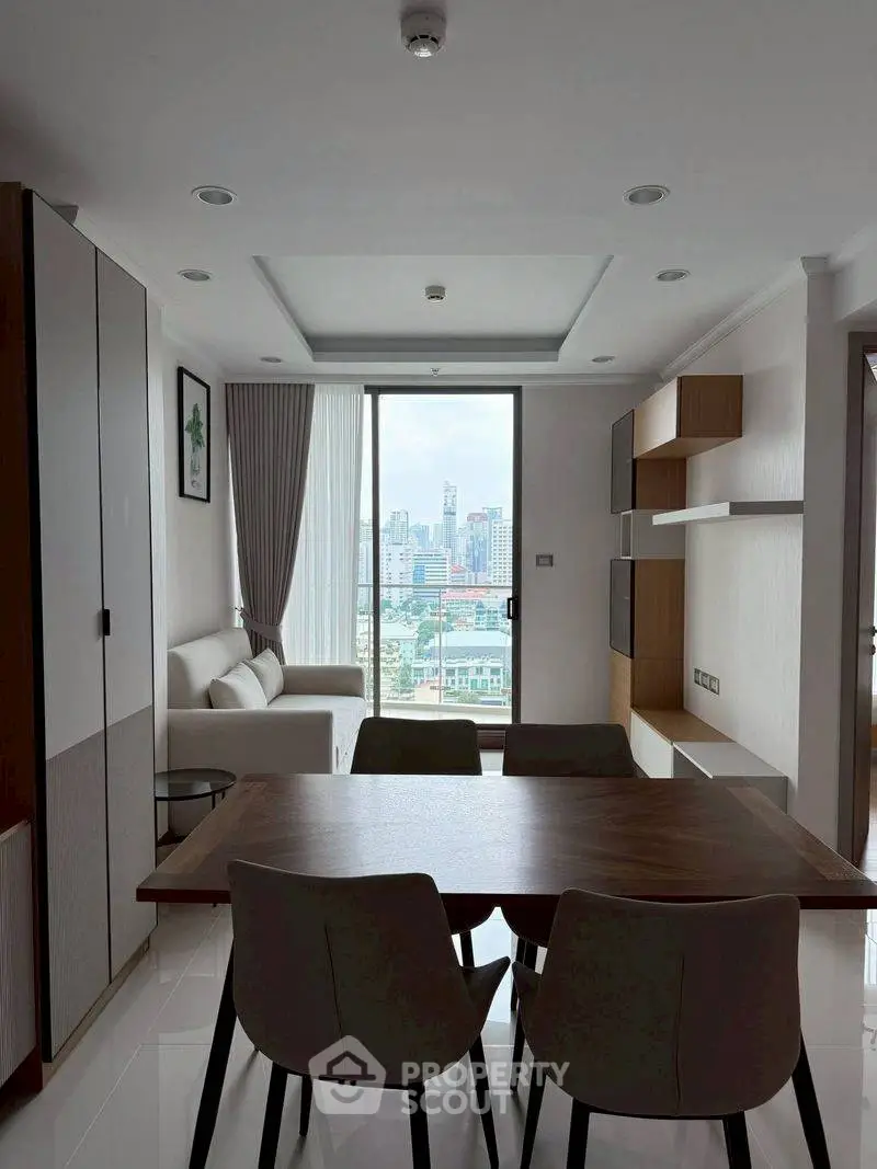 Modern living room with city view, stylish furniture, and natural light.