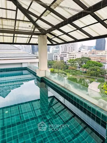 Luxurious rooftop pool with stunning cityscape views in a modern urban setting.