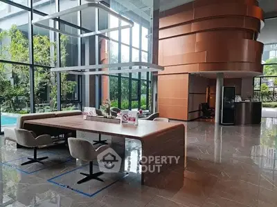 Modern building entrance with sleek design and pool view