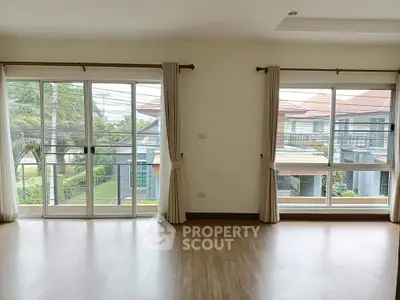 Spacious living room with large windows and garden view in modern home
