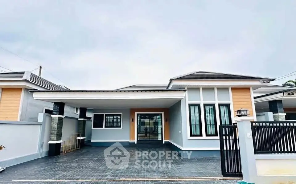 Modern single-story house with spacious driveway and stylish facade