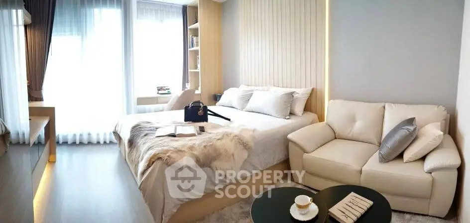 Luxurious modern bedroom with elegant decor and cozy seating area, perfect for relaxation and comfort.