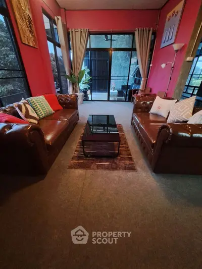 Charming living room with cozy leather sofas and vibrant decor.