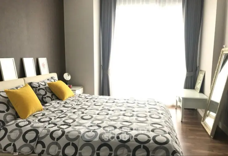 Modern bedroom with stylish decor and ample natural light