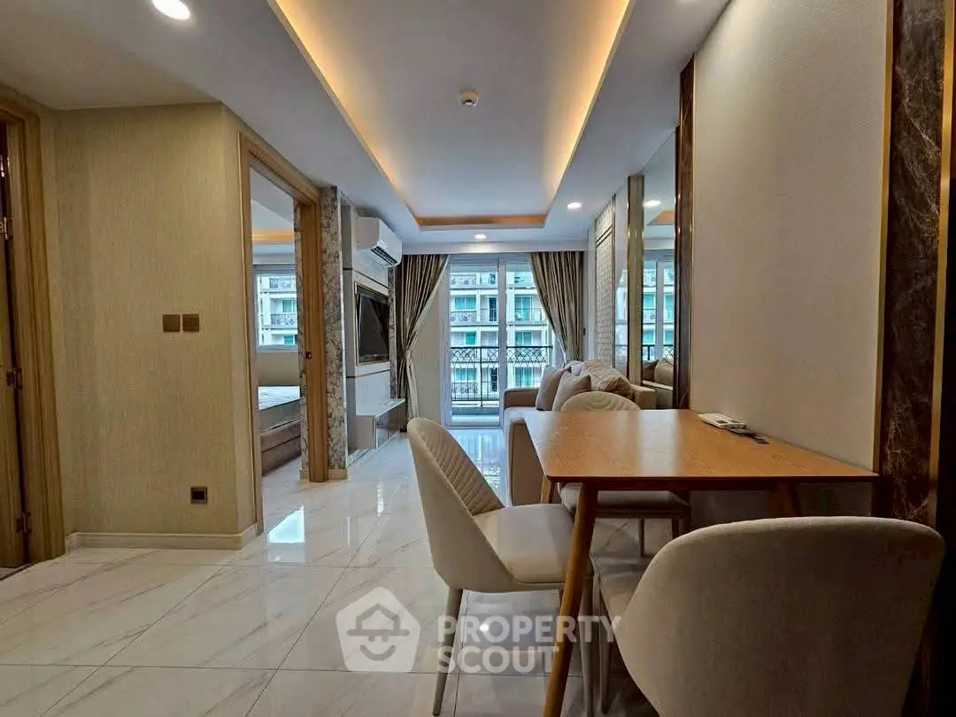 Modern apartment interior with open living and dining area, featuring elegant decor and large windows.