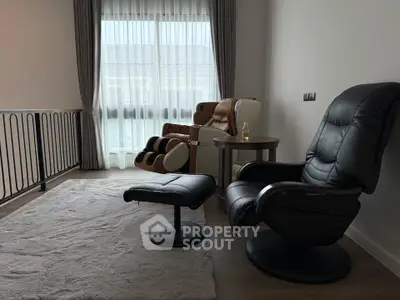 Cozy living room with massage chairs and soft rug, perfect for relaxation.