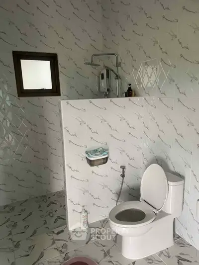 Spacious bathroom with modern fixtures and elegant tile design