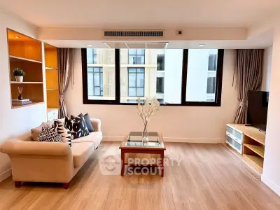 Spacious modern living room with large windows and elegant decor