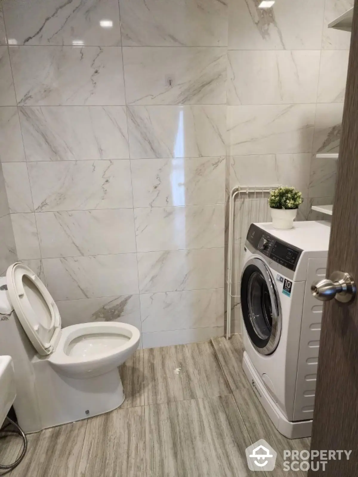 Modern bathroom with washing machine and elegant marble tiles