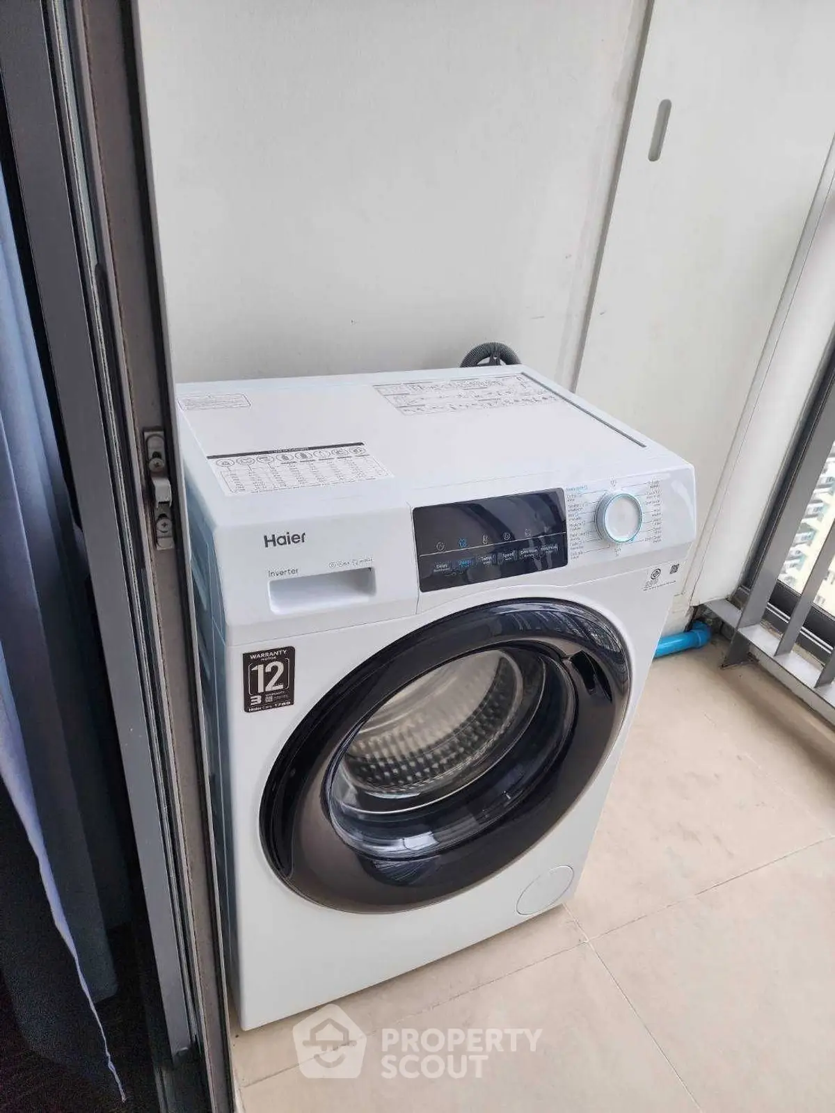 Modern washing machine on a balcony with sleek design and efficient features.