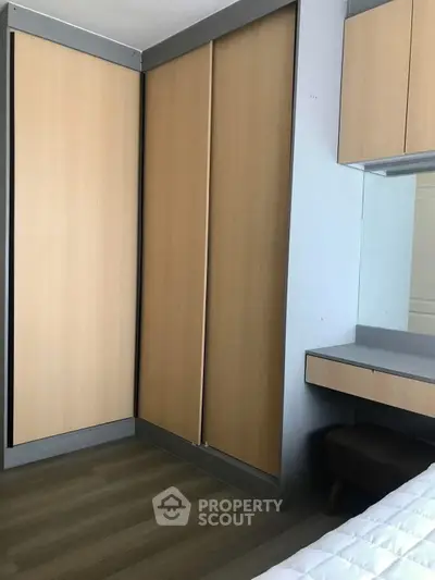 Modern bedroom with sleek built-in wardrobe and cozy workspace