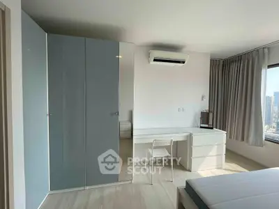 Modern bedroom with sleek wardrobe and city view, featuring minimalist design and air conditioning.