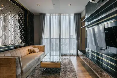 Luxurious modern living room with elegant decor and floor-to-ceiling windows offering stunning city views.