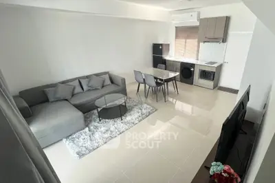 Modern living room with sleek furniture and open kitchen layout