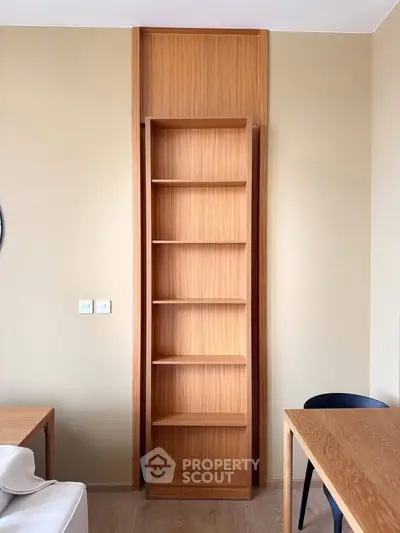 Modern living room with sleek wooden bookshelf and minimalist furniture design.