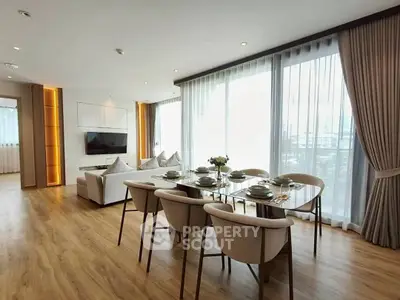 Spacious modern living room with elegant dining area and large windows.