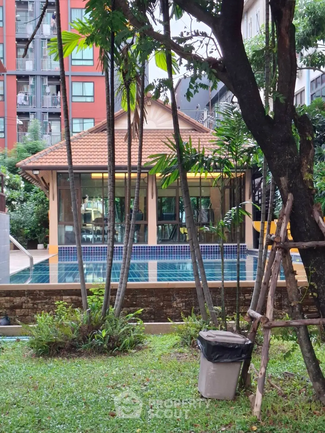 Charming residential pool area with lush greenery and modern architecture